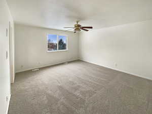 Unfurnished room with ceiling fan and carpet