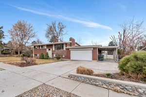 View of front of house featuring a carport and a garage