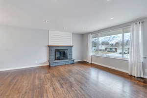 Unfurnished living room featuring dark hardwood / wood-style flooring