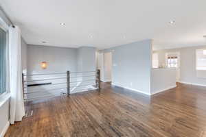 Unfurnished room with dark wood-type flooring