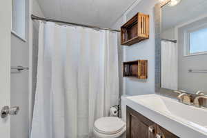 Bathroom featuring vanity, toilet, and wooden ceiling