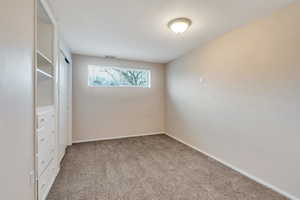 Unfurnished bedroom with a closet and light colored carpet