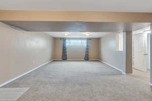 Basement with light colored carpet