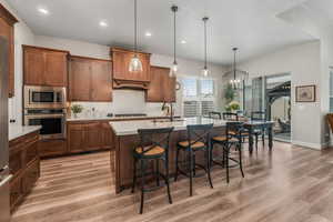 Kitchen featuring a large center island, pendant lighting, and stainless steel appliances