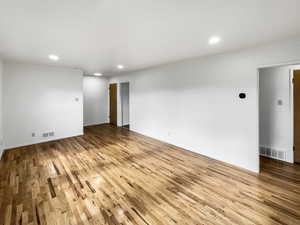 Empty room with light hardwood / wood-style floors