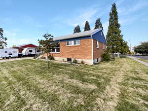 View of side of property with a yard