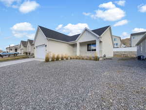 View of front of house featuring central AC and a garage