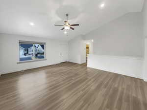 Empty room with light hardwood / wood-style floors, lofted ceiling, and ceiling fan