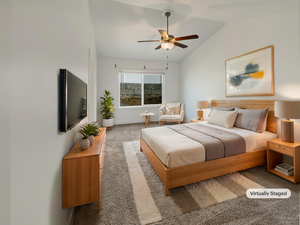 Bedroom featuring dark carpet, ceiling fan, and vaulted ceiling