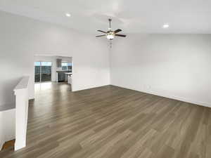 Unfurnished living room with dark wood-type flooring and ceiling fan