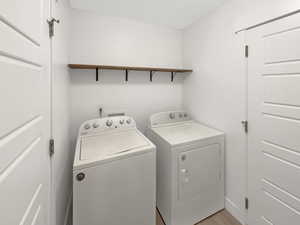 Washroom featuring light wood-type flooring and separate washer and dryer