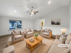 Living room featuring ceiling fan, light hardwood / wood-style floors, and lofted ceiling