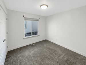 Empty room with dark carpet