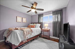 Bedroom with dark hardwood / wood-style floors and ceiling fan