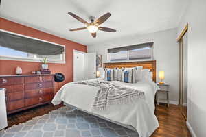 Bedroom with ceiling fan and dark hardwood / wood-style flooring