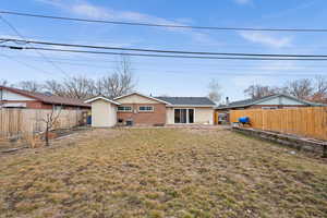 Back of house featuring a patio area and a yard