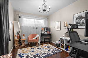 Office featuring a chandelier and dark hardwood / wood-style floors