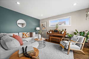 Living room with hardwood / wood-style flooring