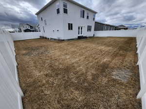 Rear view of house with a lawn