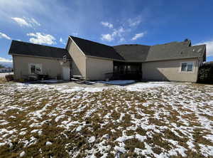 View of snow covered rear of property