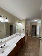 Bathroom with vanity and crown molding