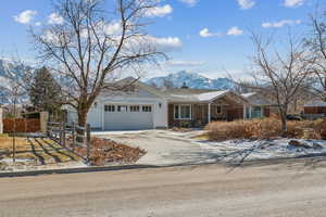 Ranch-style house featuring a mountain view and a garage