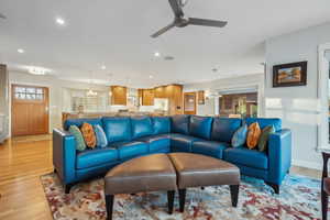 Living room featuring light hardwood / wood-style floors and ceiling fan