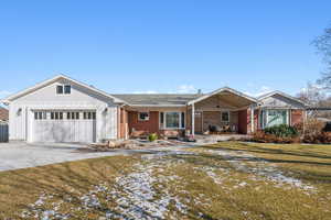 Single story home featuring a yard and a garage