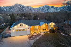 View of front of home with a mountain view and a garage