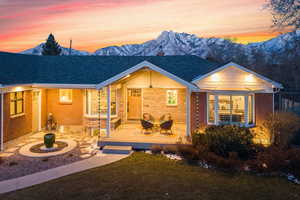 View of front of property with a lawn and a mountain view