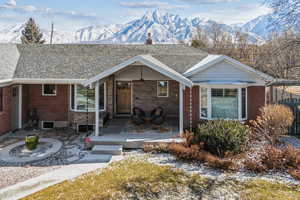 View of front of house with a deck with mountain view