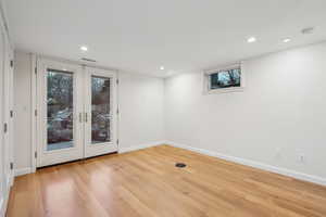 Spare room with light hardwood flooring and french doors