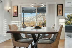 Dining room with a mountain view and light hardwood / wood-style flooring