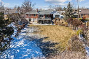 Rear view of property with a patio area and a lawn