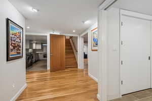 Hallway with sink and light hardwood / wood-style floors