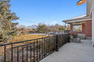 Balcony featuring a mountain view and ceiling fan