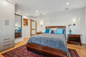 Bedroom featuring light hardwood / wood-style flooring and a barn door