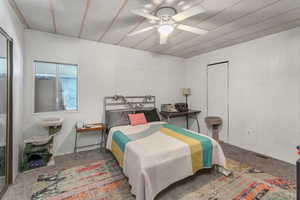 Carpeted bedroom with ceiling fan