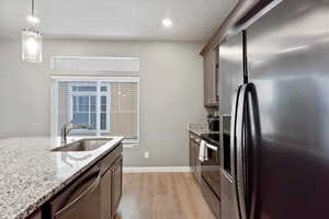 Kitchen featuring black stainless-steel appliances, single basin sink, and granite countertops