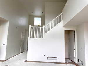 Stairway featuring a high ceiling