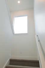 Stairway featuring baseboards and recessed lighting