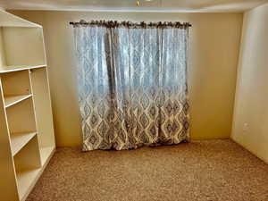 Carpeted spare room featuring a textured ceiling