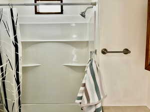 Bathroom featuring curtained shower