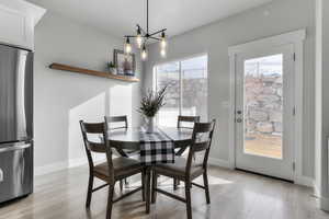 Dining area featuring light wood-type flooring and a chandelier