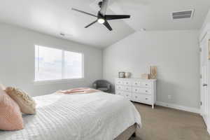 Bedroom with light carpet, vaulted ceiling, and ceiling fan