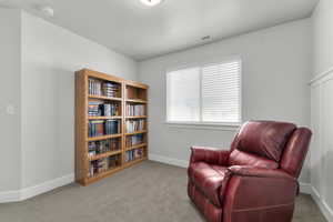 Sitting room featuring light colored carpet