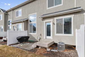 Back of house featuring central air condition unit and a patio area