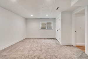 Spare room with a textured ceiling and carpet floors