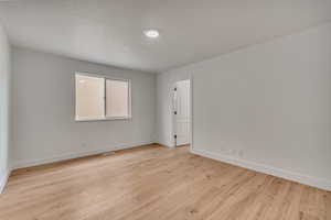 Spare room with light wood-type flooring