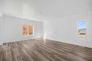 Spare room featuring wood-type flooring